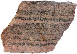 <p>This rock is typically banded, and alternates light and dark bands. It is foliated, and is therefore regional metamorphism. It is the highest grade of metamorphosed shale. It can also be made from granite. </p>