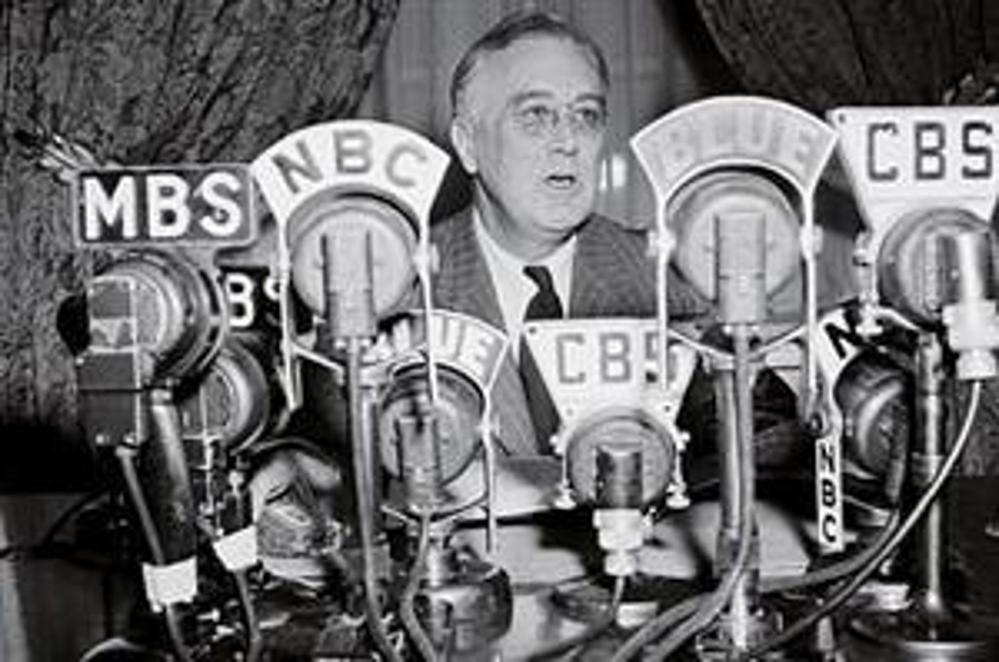 <p>using the radio to update the American public on the government's response to the Great Depression</p>
