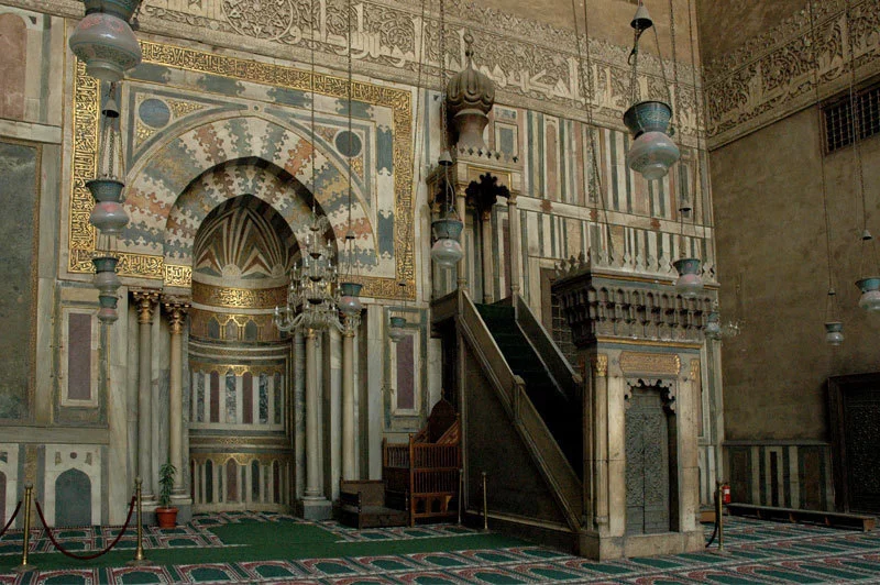 <p>a decorated wall of a mosque that faces towards Mecca. the minbar is also located here</p>
