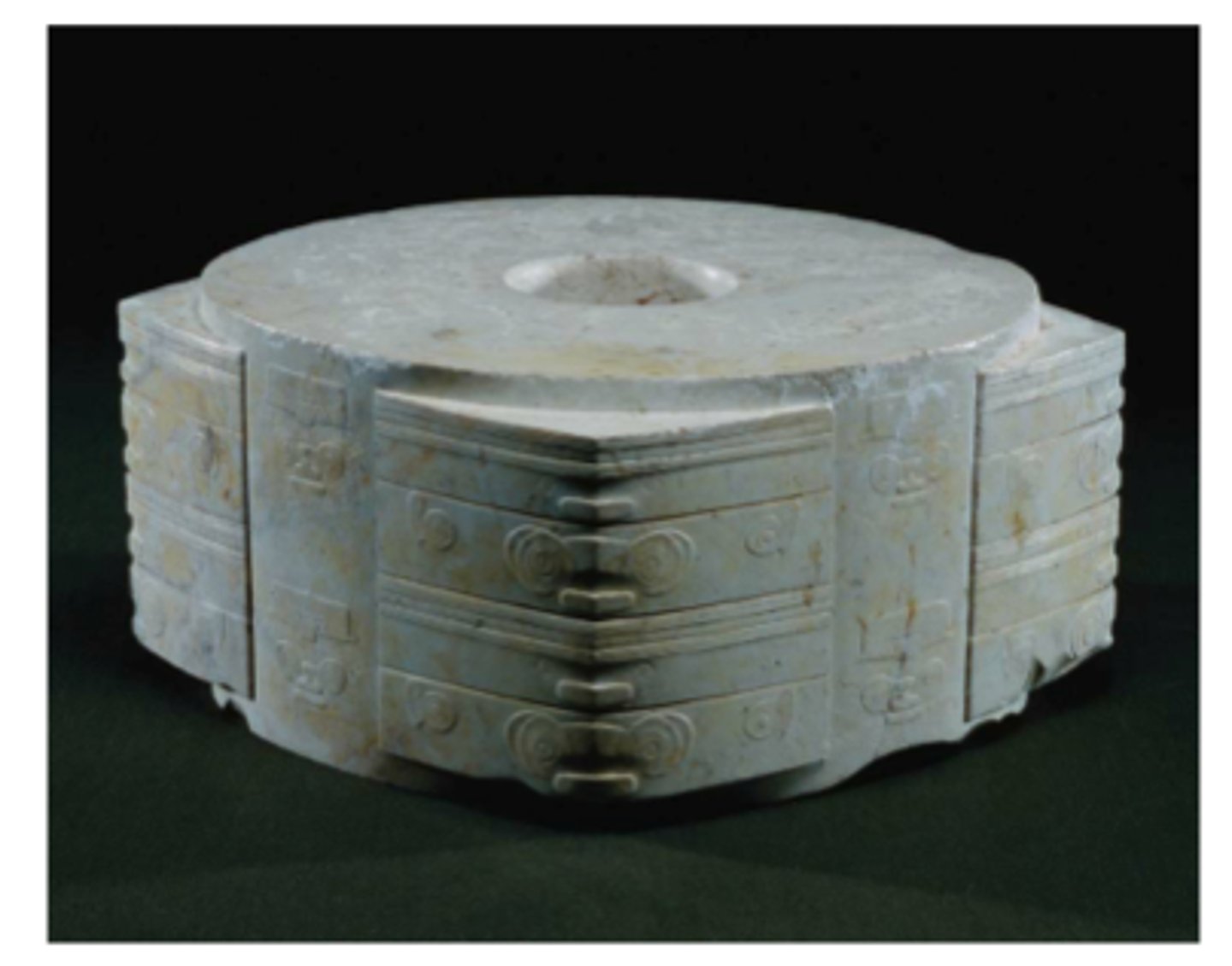 <p>a tubular object with a circular hole cut into a square-like cross section</p>