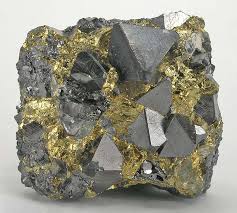 <p>Gray/blackish brown, is metallic with a 5.5-6ish hardness, leaves a black streak behind, and is highly magnetic</p>