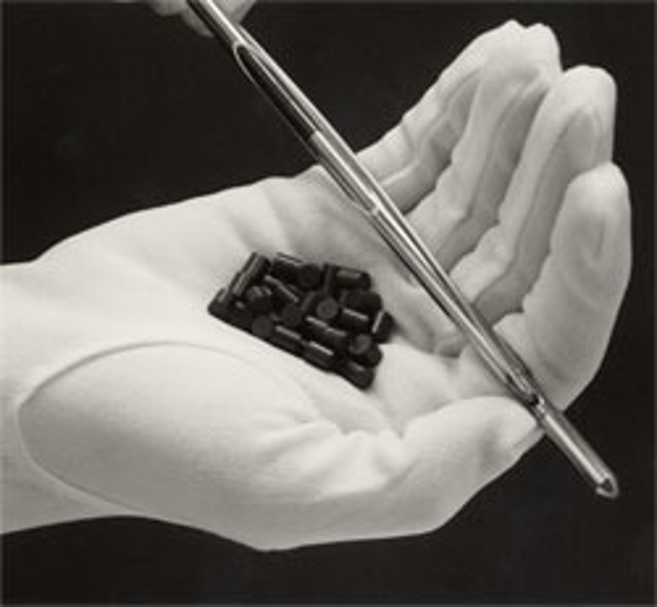 <p>pellets of uranium arranged in long steel cylinders</p>