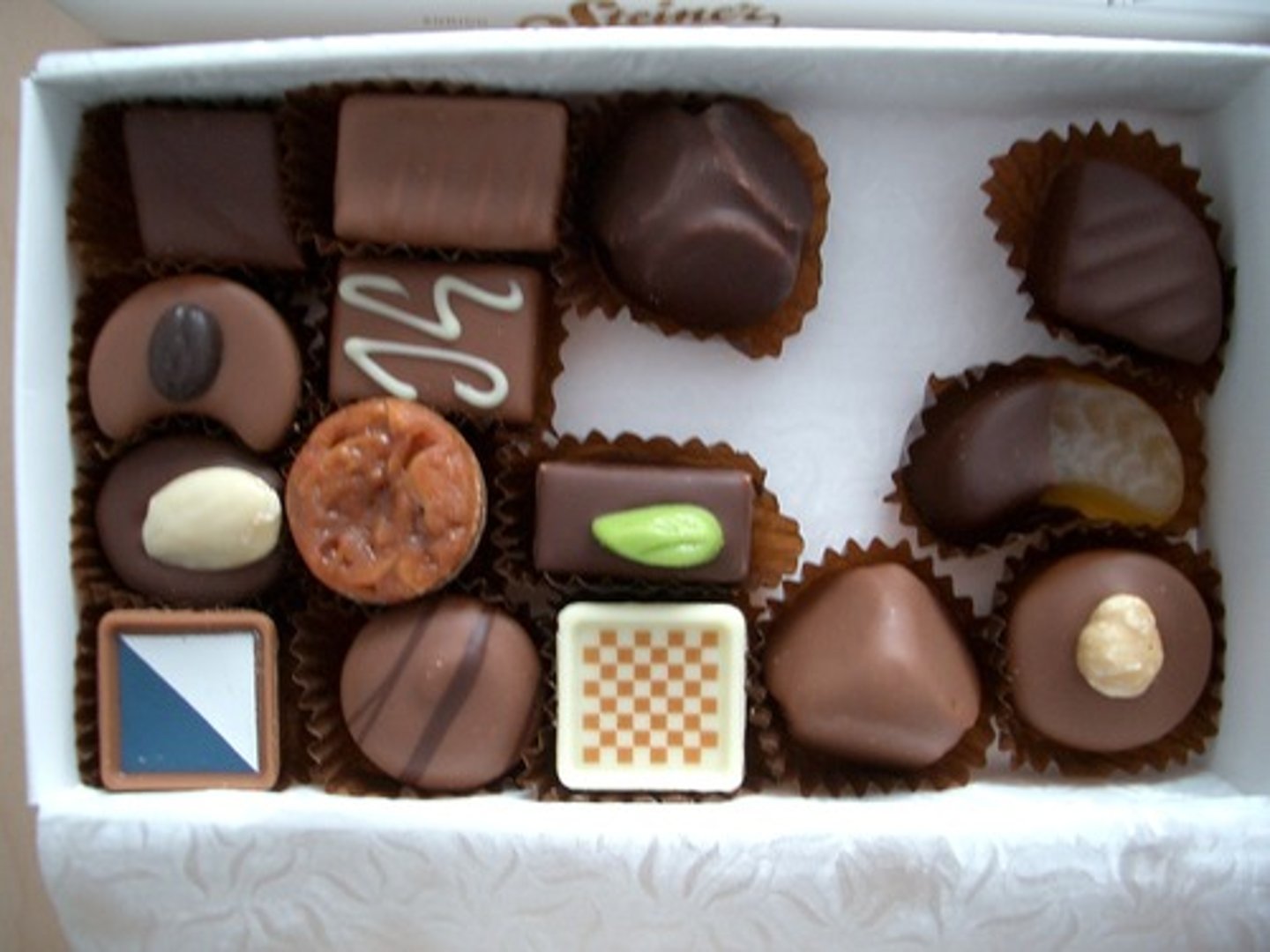 <p>Chocolate confections that are often filled with cream, nuts, or fruit.</p>