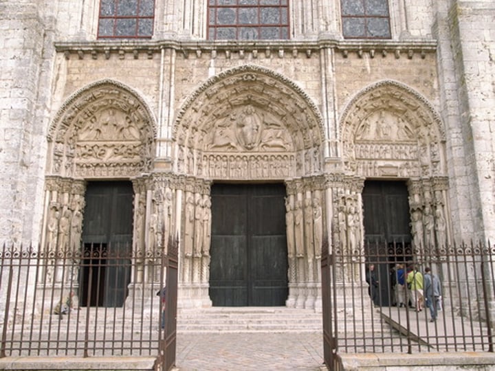 <p>Chartres, France c. 1145-1155; West Façade; some of the figures carved on the portals are French kings; three typanums; 1. christ in center with mandorla surrounded by four evangelists 2. Mary with Christ in her lap 3. Christ's ascension to heaven; Gothic art</p>