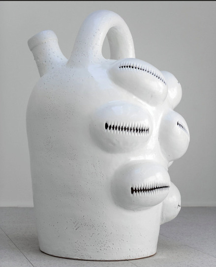 <p>Meaning: <span style="background-color: transparent;"><span>A large sculpture inspired by traditional face vessels and cowrie shells, exploring Black feminist themes of resilience, self-determination, and reclaiming history. It transforms symbols of oppression into figures of empowerment and cultural continuity.</span></span></p>