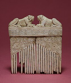 <p>Ivory comb with lions on top</p>
