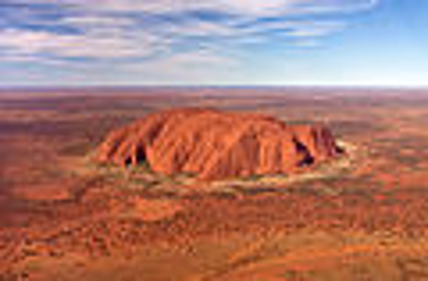 <p>A natural landmark that people visit located in the Outback, also known as Uluru.</p>