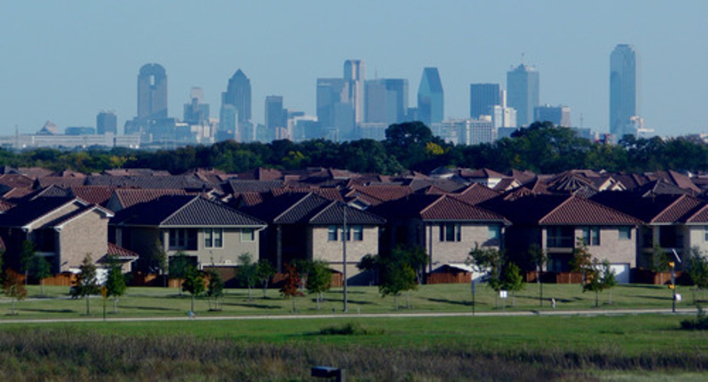 <p>metropolitan areas sprawl in all directions and suburbs take on many of the characteristics of traditional downtowns</p>