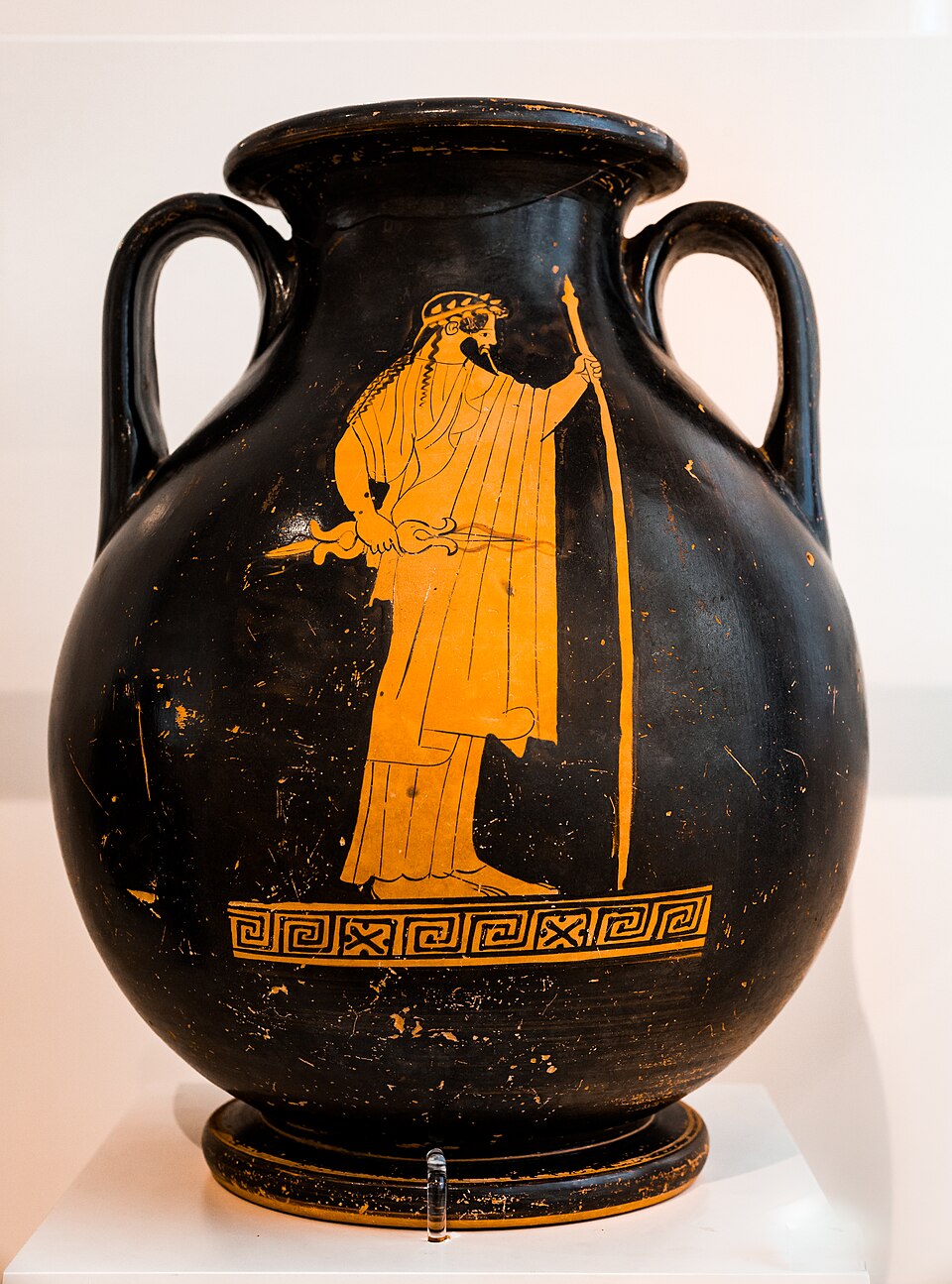 <p>Full standing portrayal of Zeus demonstrates the&nbsp;“red figure” (background is painted black around the image which is left in the natural orange color of the clay. The pose is relaxed.&nbsp;</p>