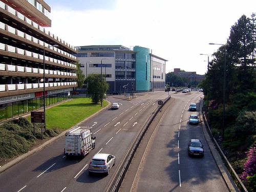 A two way road divided by a strip of land in the middle.