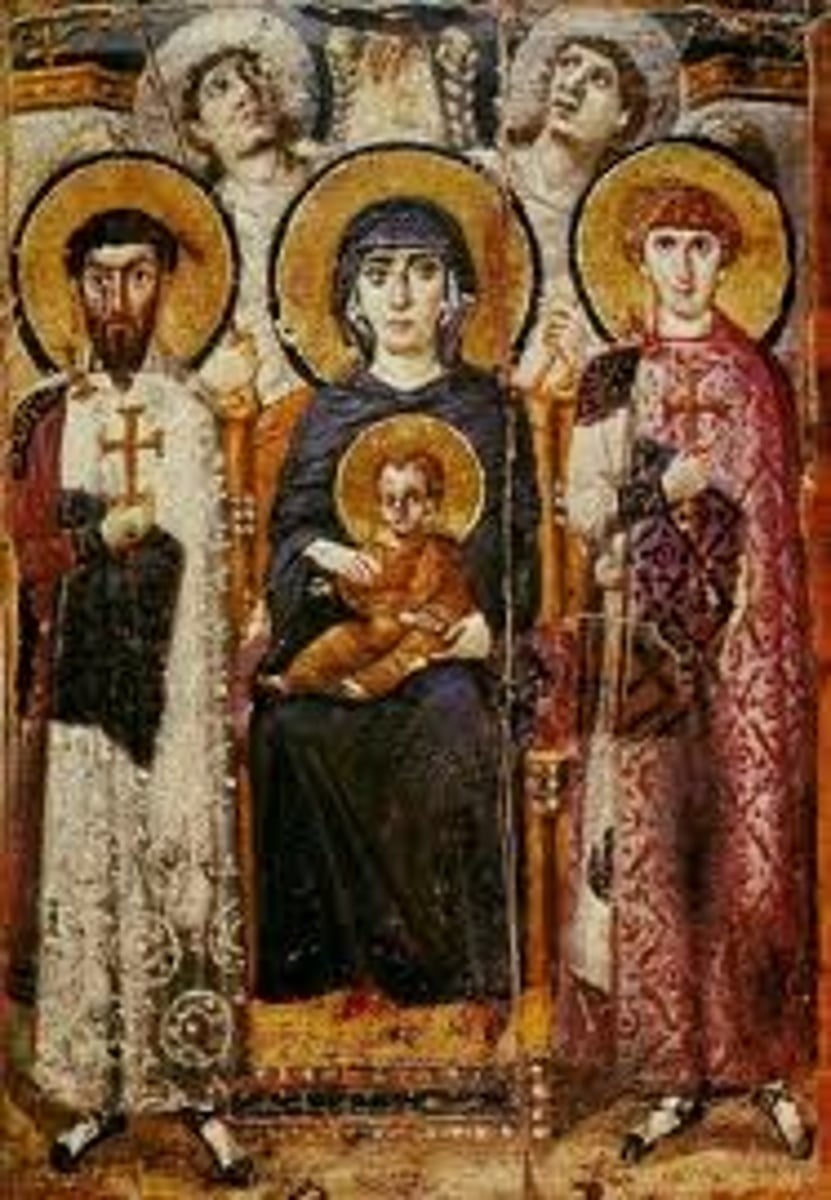 <p>A Byzantine icon depicting the Virgin Mary and Child flanked by two saints, emphasizing the veneration of Mary (Theotokos) in Christian iconography.</p>