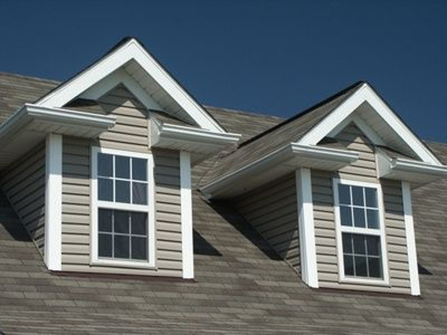 <p>a vertical window in a projection built out on a sloping roof</p>