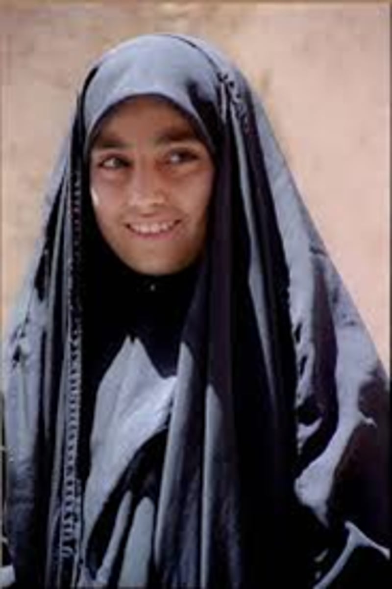 <p>full length cloak worn by iranian women typically held closed at front by wearers hand or under arms</p>