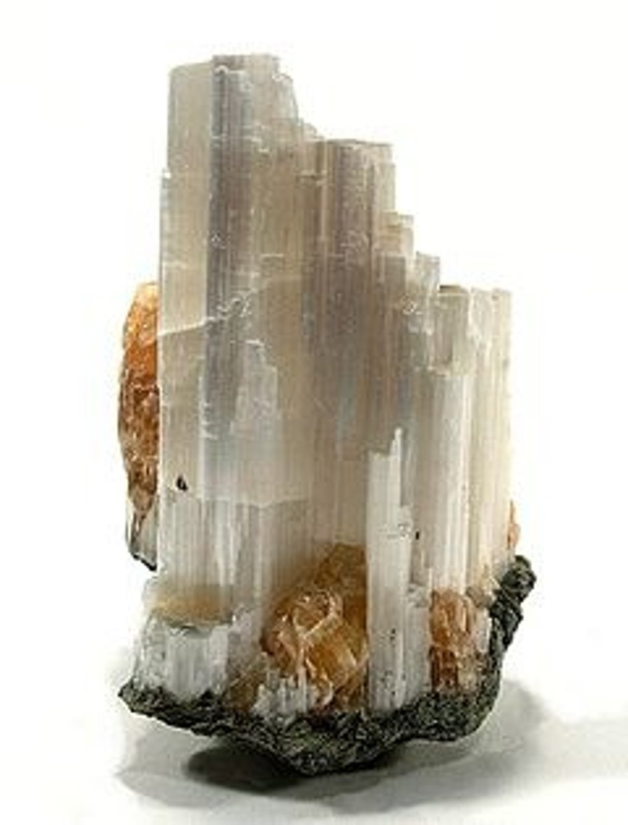 <p>Almost always white, and looks like a densely-packed bundle of white threads, opaque in one direction, and conducts light in the other. "TV rock."</p>
