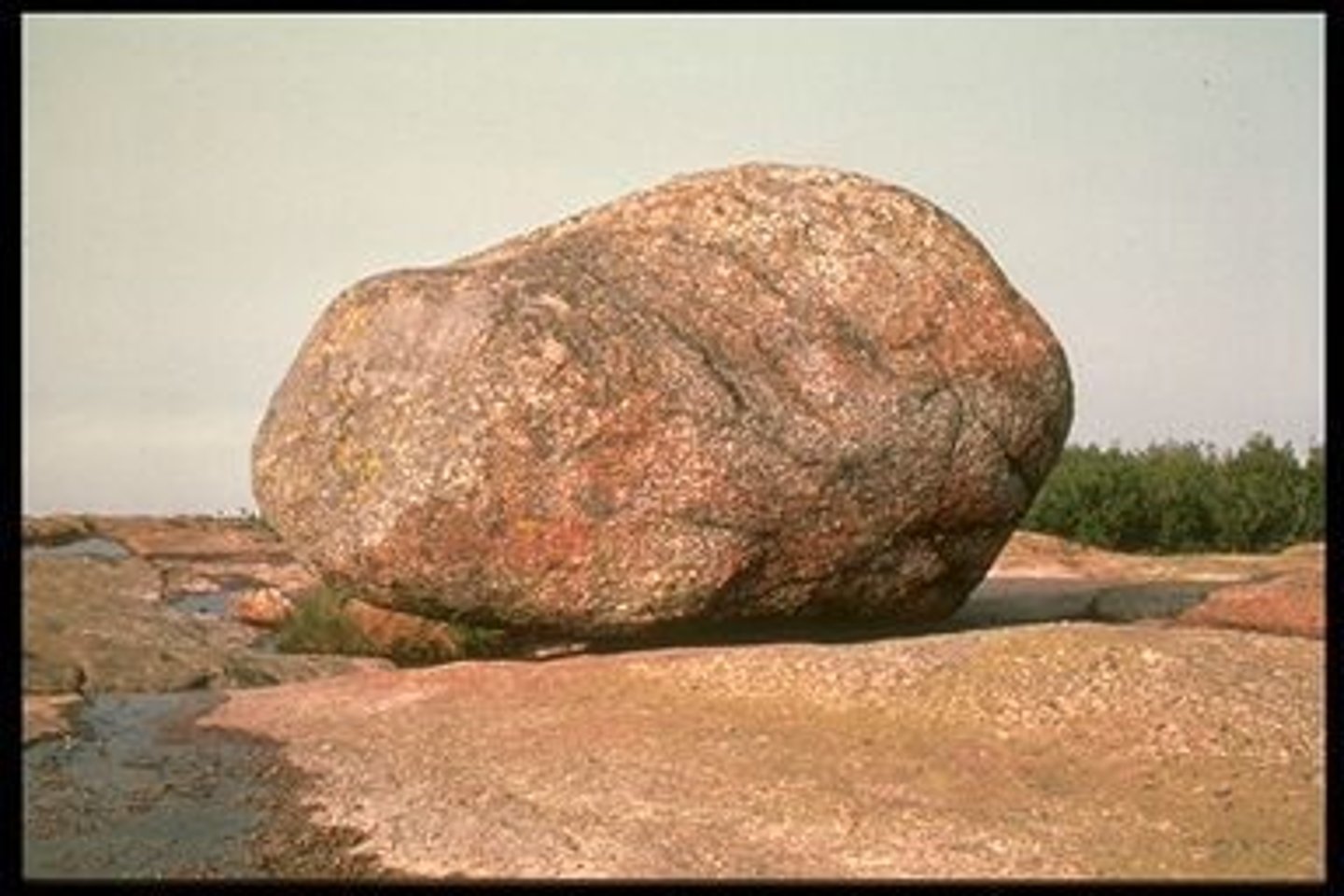 <p>a large boulder moved and dropped by a glacier</p>