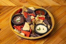 <p>F<span>ire roasted salsa, queso blanco, refried black beans with cotija cheese, tortilla chips.</span></p>
