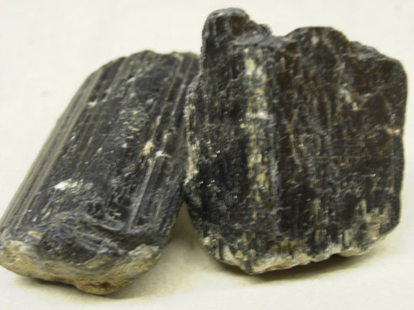 <p>-Black/white/yellow color<br>-56 degree and 124 degree angles<br>-Doesn't have a square cleavage <br>-No streak<br>-Hardness 5.5</p>