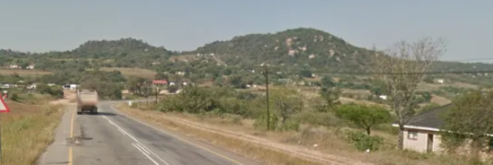 <p>Green wooded hills and tall golden grass</p>