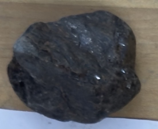 <p>Kinda metallic, dark grey/brown, stinky marks</p>