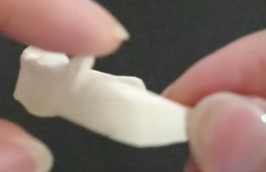 the point (what her left index finger is touching)