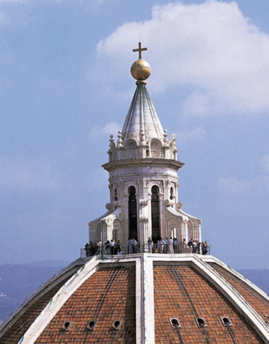 <p>a small structure with openings for light that crowns a dome</p>