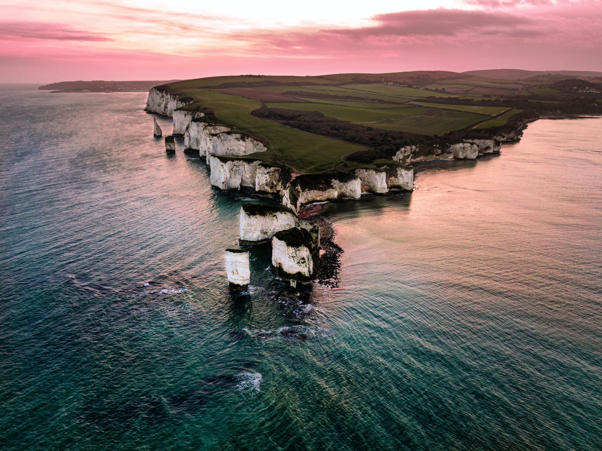 <p><strong>Old Harry’s Rock</strong>:</p><ul><li><p>Erosion attacked the base of chalk cliffs, forming caves.</p></li><li><p>The caves widened and became arches.</p></li><li><p>The arches collapsed, leaving stacks.</p></li></ul><p></p>