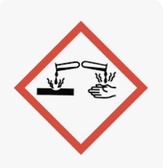 <p><span>A chemical symbol indicating a substance that can cause visible destruction or irreversible alterations to living tissue by chemical action at the site of contact</span></p>