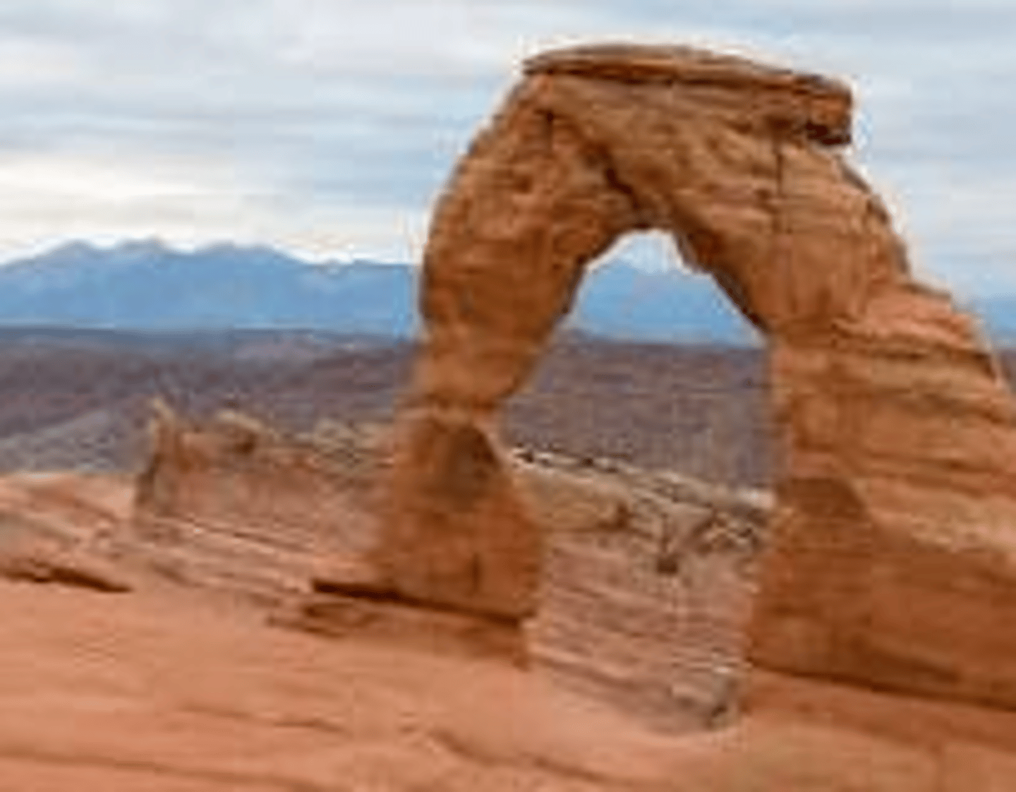 <p>a natural rock formation where an arch has formed with an opening underneath</p>