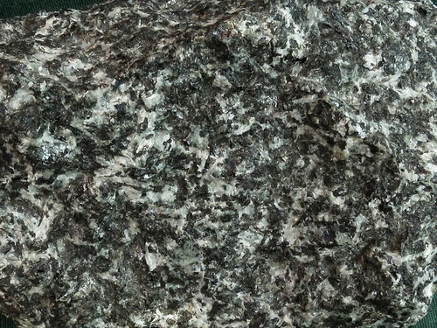 <p>An overall dark, coarse-grained rock with identifiable crystals of plagioclase and dark pyroxene. Even-grained with no phenocrysts</p>