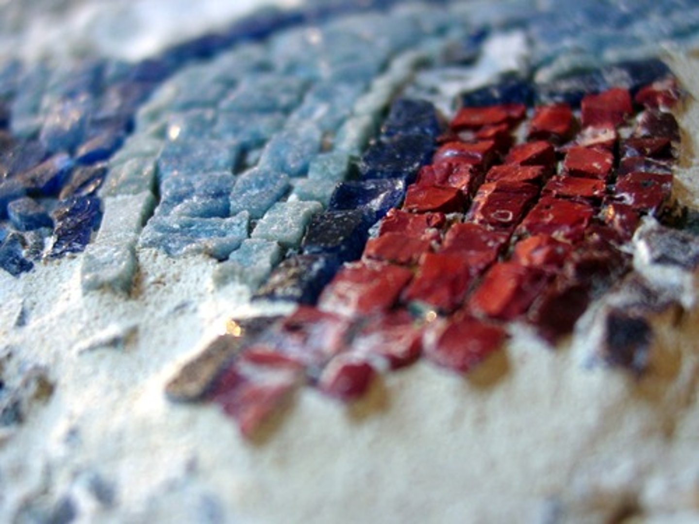 <p>one of the small pieces of colored marble, glass, or tile used in mosaic work</p>