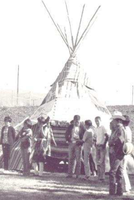 <p>Covered with rush mats and an animal skin door, conical tent with wooden poles as framework</p>