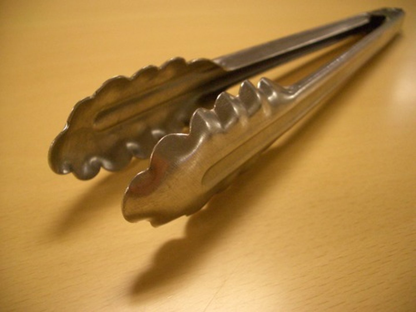 <p>A scissor-like utensil foodhandlers use to pick up and handle all kinds of solid food.</p>