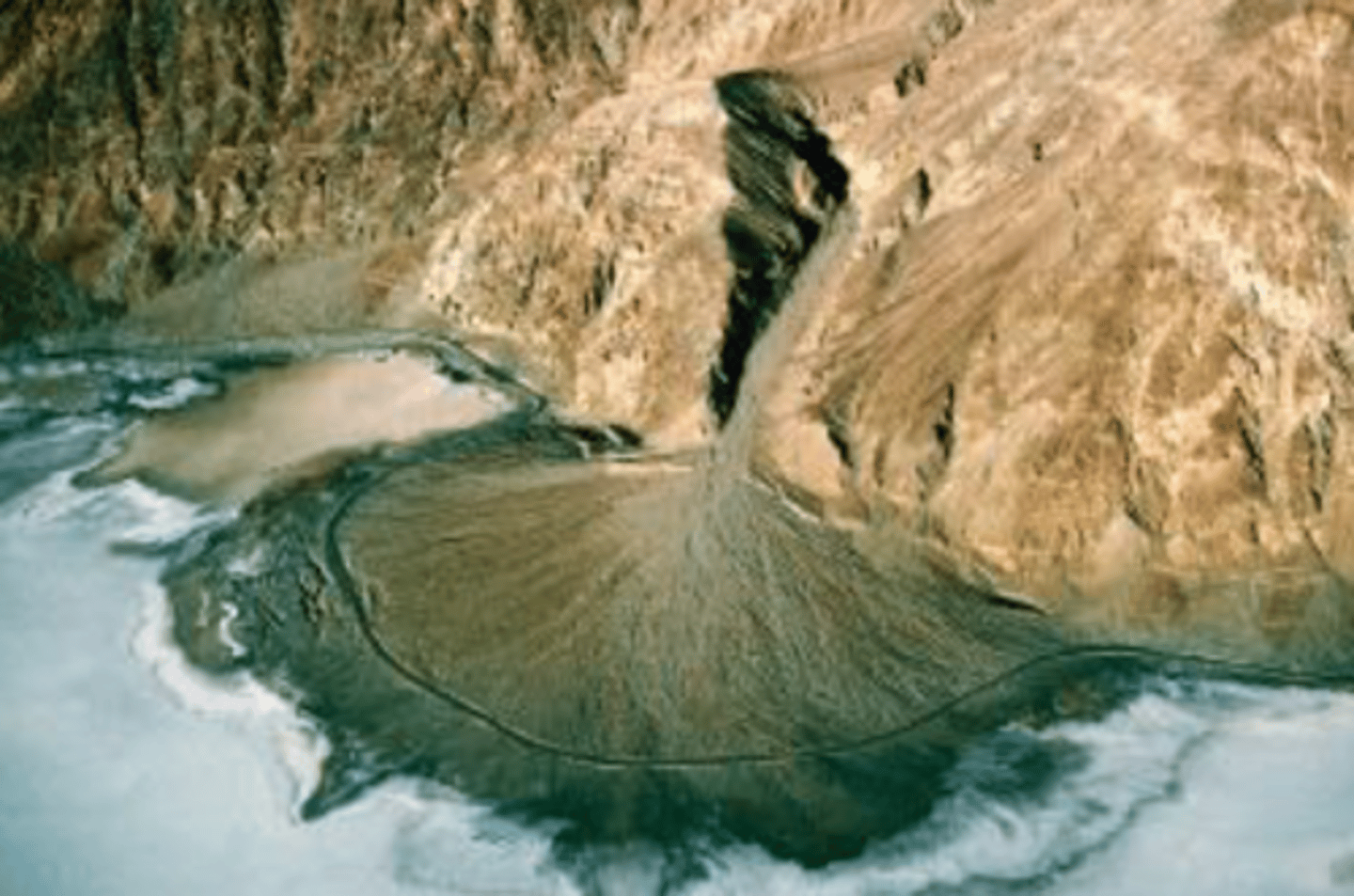 <p>A fan-shaped deposit of stream sediment formed on a gently sloping or flat valley floor at the base of a mountain where a stream's slope and velocity are abruptly reduced.</p>