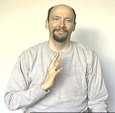 <p><span style="font-size: medium">Stick the tip of your thumb on your chest and wiggle the fingers.</span></p>