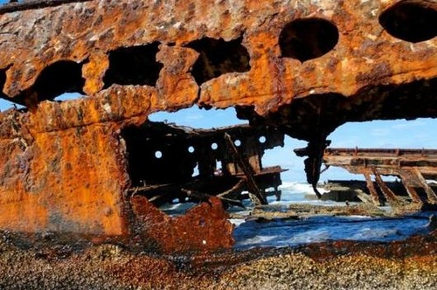<p>Oxidation of metal, for example rust where cathode = oxygen and water and anode = iron</p>