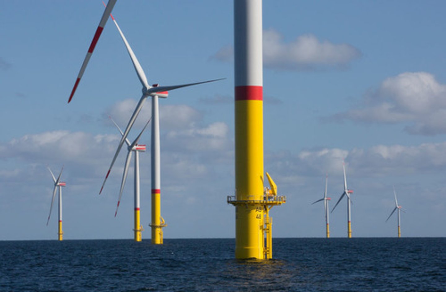 <p>wind farms located in bodies of water. wind is stronger here so turbines generate more electricity, but transmission lines must be built further to get electricity to land where it will be used</p>