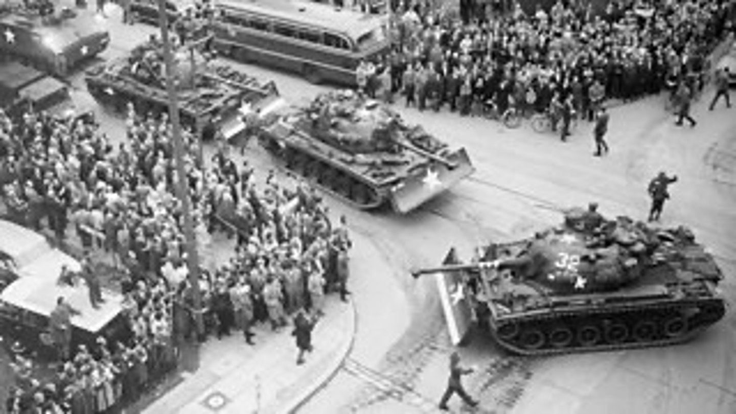 <p>During the early part of August 1961, the foreign ministers of the US, UK, and France met to discuss the crisis in Berlin. A key concern of US and its allies was to keep access to West Berlin free under all circumstances, while ensuring tensions did not escalate into a wider conflict/war with the USSR.</p><p>Once the Wall had been constructed, the US decided to test how far they could push the USSR. Foreigners were still allowed to cross the wall, and the US regularly sent troops and diplomats into the Soviet sector through Checkpoint Charlie, one of the guarded crossing points between East and West Berlin. Both sides were entitled to do this under an agreement made after the Yalta Conference.</p>