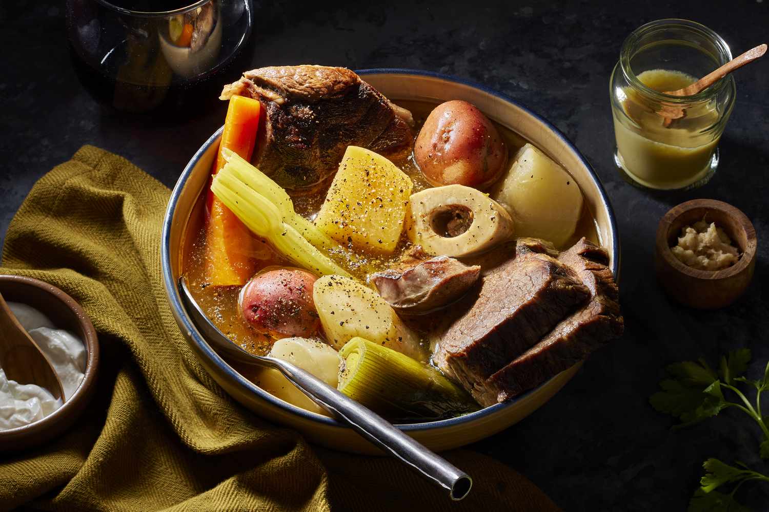 <p>a French dish of slowly boiled meat and vegetables, usually served as two courses: first the broth (<em>bouillon</em>) and then the meat (<em>bouilli</em>) and vegetables.</p>