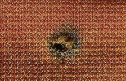 Bullet wipe consisting of soot, carbon, and other soiling materials is noted on the bloody clothing of a shooting victim.