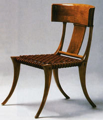 light, armless chair with outward curved front, rear legs, and an inwardly curved backrest