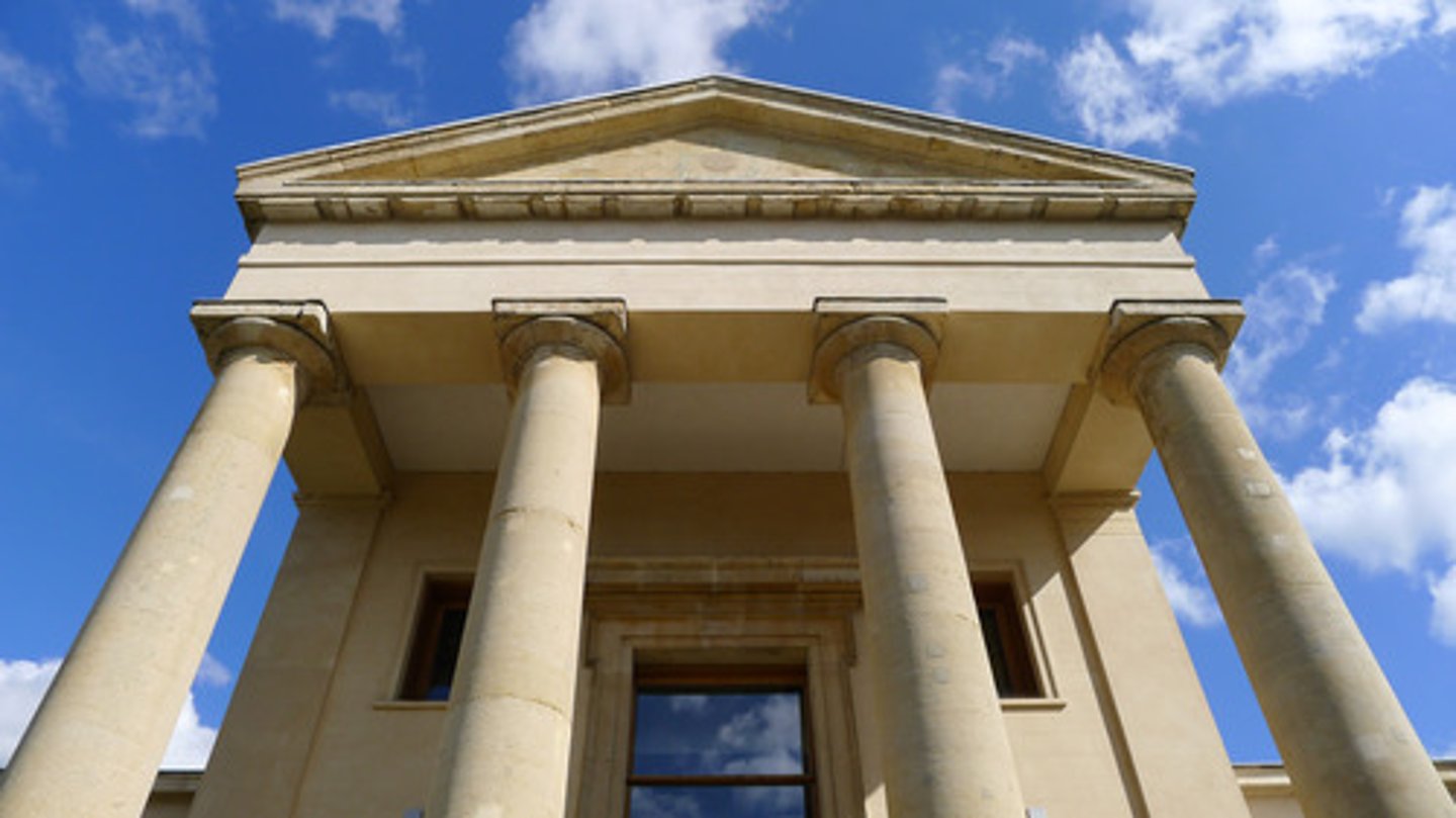 <p>a colonnade or covered ambulatory especially in classical architecture and often at the entrance of a building</p>