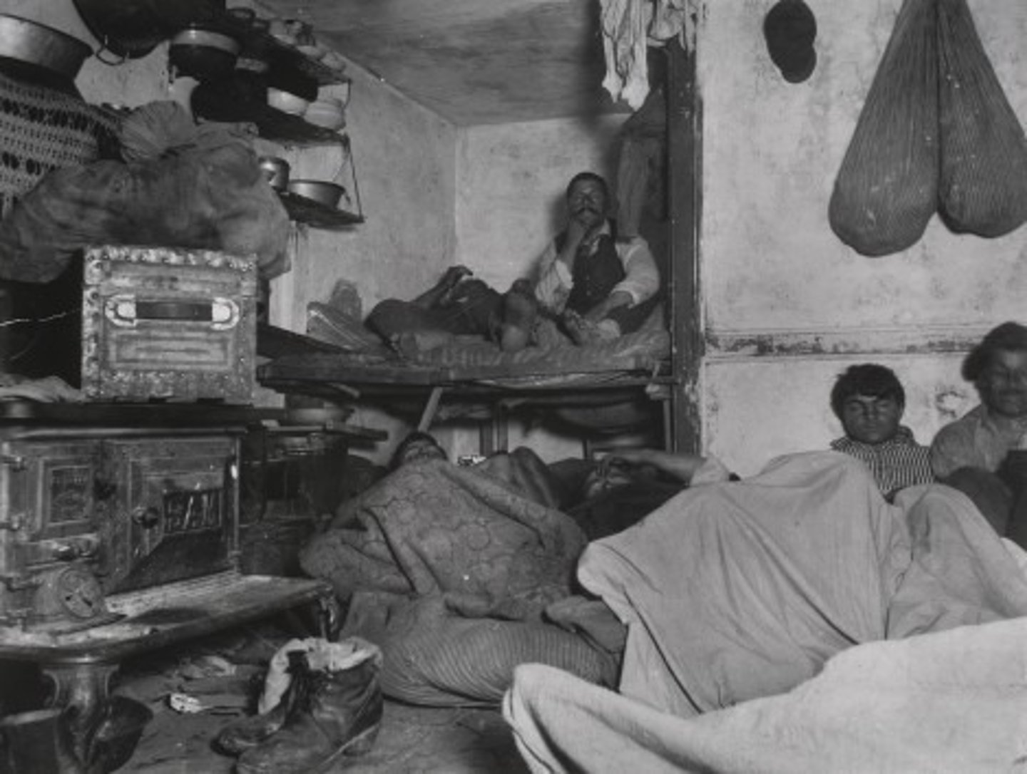 <p>A building in which several families rent rooms or apartments, often with little sanitation or safety</p>