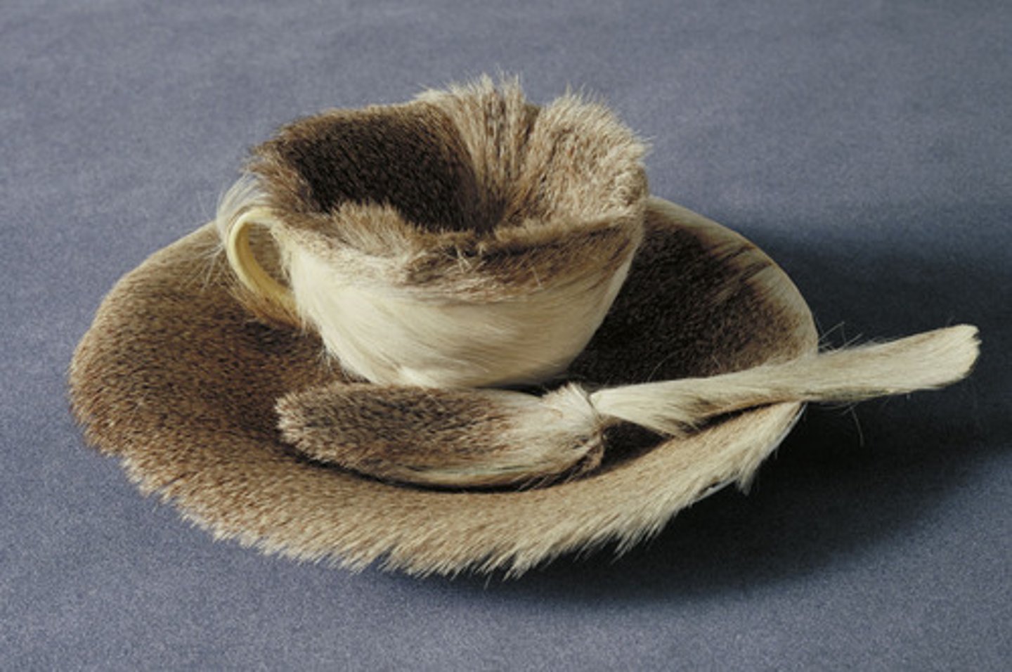 <p>1936. Meret oppenheim. Fur-covered cup, saucer, spoon. Surrealism<br>Oppenheimer created this to respond to Picassos "everything looks good in fur"<br>May not be true--could be a myth, not knowing the truth = surrealist?<br>Nasty physical sensation, imagine ourselves drinking tea from a wet fur cup. Revulsion<br>Subversion of expectations: cups=smooth, porcelain, metal, ceramic.<br>LIKE DADA: ready made, made useless<br>Quinttisentail work of surrealism: invited others to experience it with their imagination<br>Some claim the use of fur imbues functional hand-held objects with sexual connotation BUT never said<br>Oppenheim left the public, came back and said this "nobody will give you freedom, you have to take it. Women should rebel against social norms"<br>Was retitled "LUNCHEON IN FUR"<br>References LUNCHEON IN GRASS which shows a YOUNG NAKED WOMAN surrounded by clothed men. PROVOCATIVE, SENSATIONAL.<br>VENUS IN FURS - EROTIC NOVEL<br>People began to see it with erotic overtones - perception stuff<br>WOMEN ARTIST → WOMEN ARTWORK, FEMINIST WORK<br>SHOEHORNED INTO MINORITY GENRE</p>