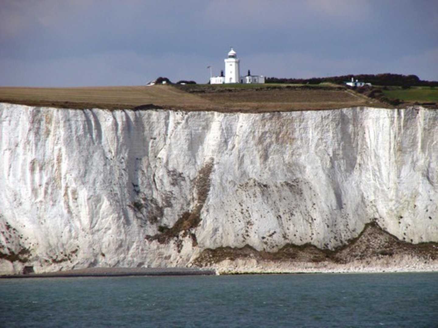 <p>boulder clay <br><br>- known as a drift deposit or glacial till<br><br>- a thick blanket of rock that was eroded by an ice sheet and ground up into clay during the ice age <br><br>- dragged and eventually deposited as ice sheets melted away<br><br>... repositioned the coastline by filling in a previous chalk bay with glacial deposits</p>