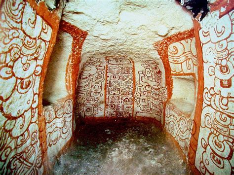 <p>Early Classic. White plaster background with designs painted on in red and black paint. Jaguar god of the underworld on far wall. Niches on left and right for offerings. Long count date on back (8, 1, 13…must be year 74 CE)</p>
