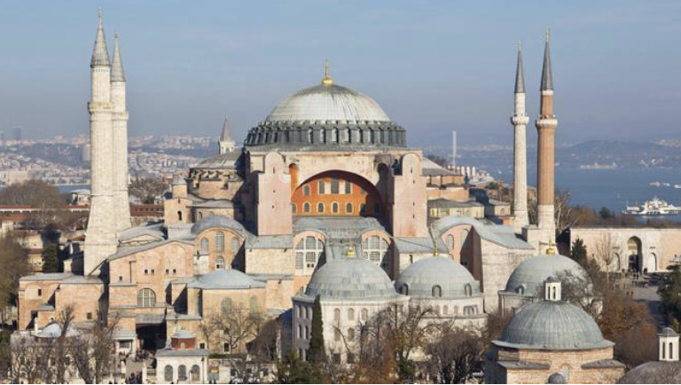<p><span style="color: purple;"><span>Hagia Sophia, Constantinople (Istanbul), Turkey, 532–37 CE. Architects Anthemius of Tralles and Isidorus of Miletus.<br>The external buttresses and four minarets were added later</span></span></p>